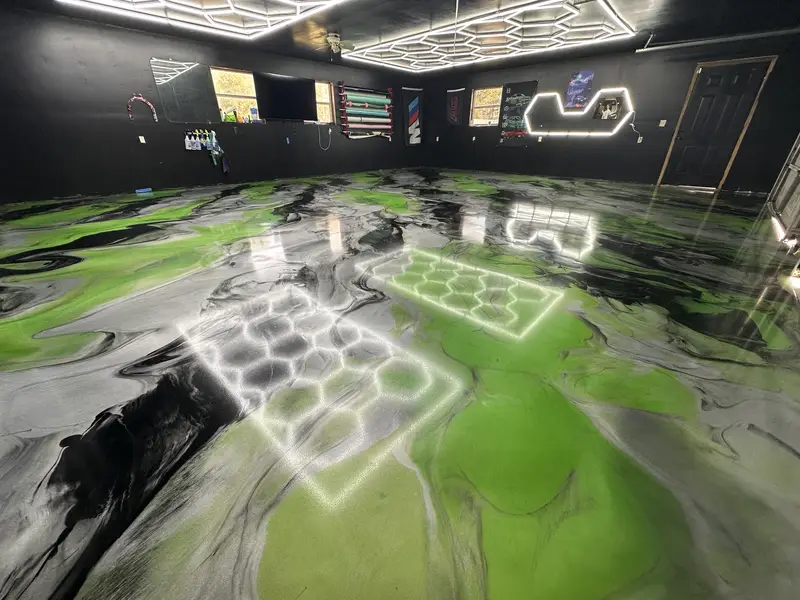 Green metallic epoxy garage floor under hexagon lights