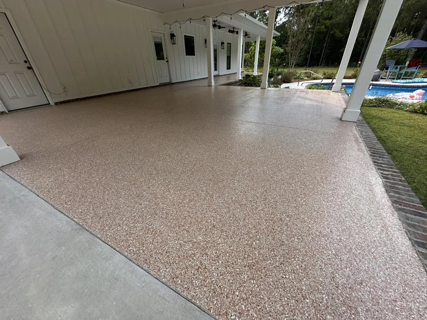 Covered pool patio after a tan flake concrete coating